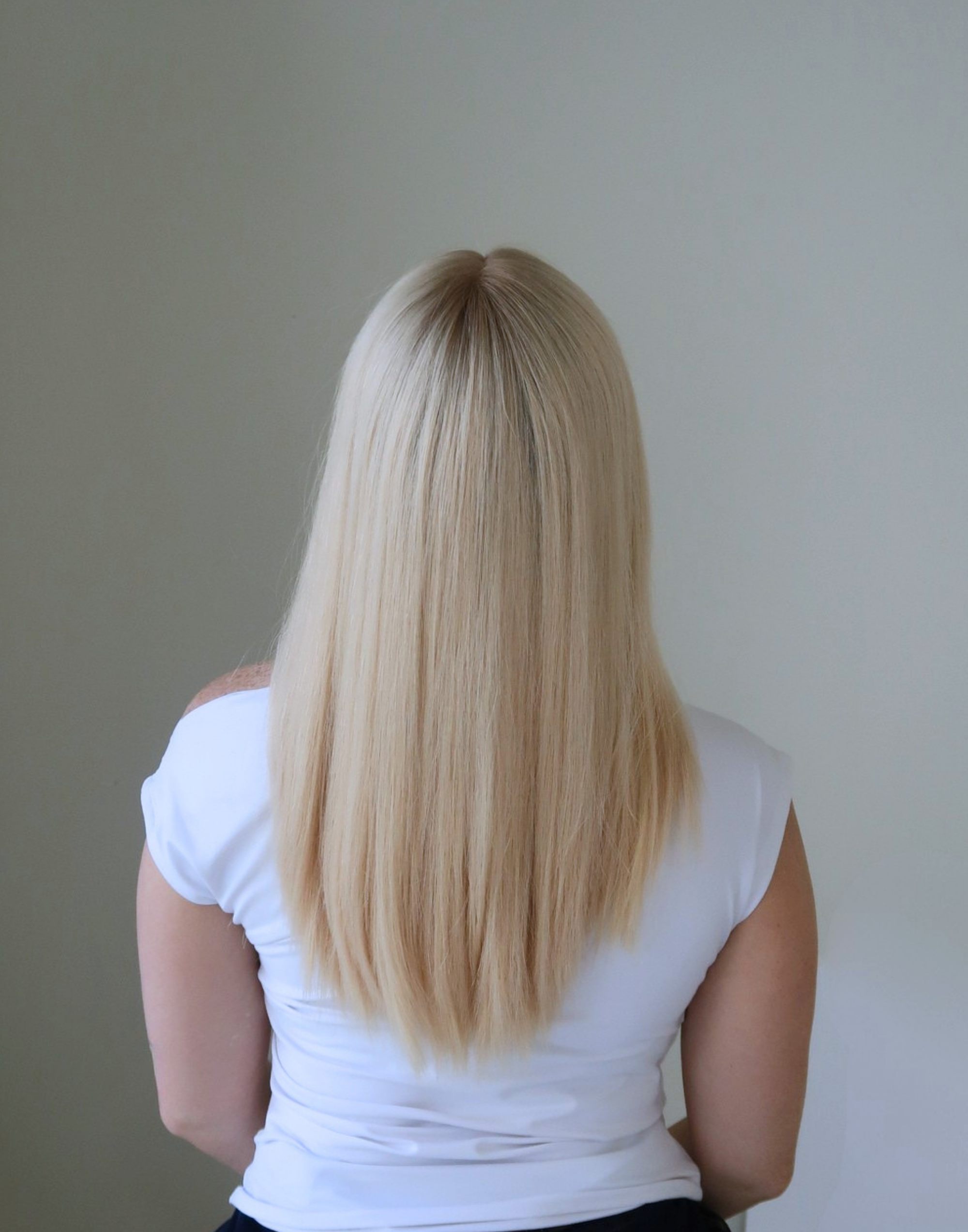 Back view of the Pearle wig showing its 20-inch length and pearl blonde color