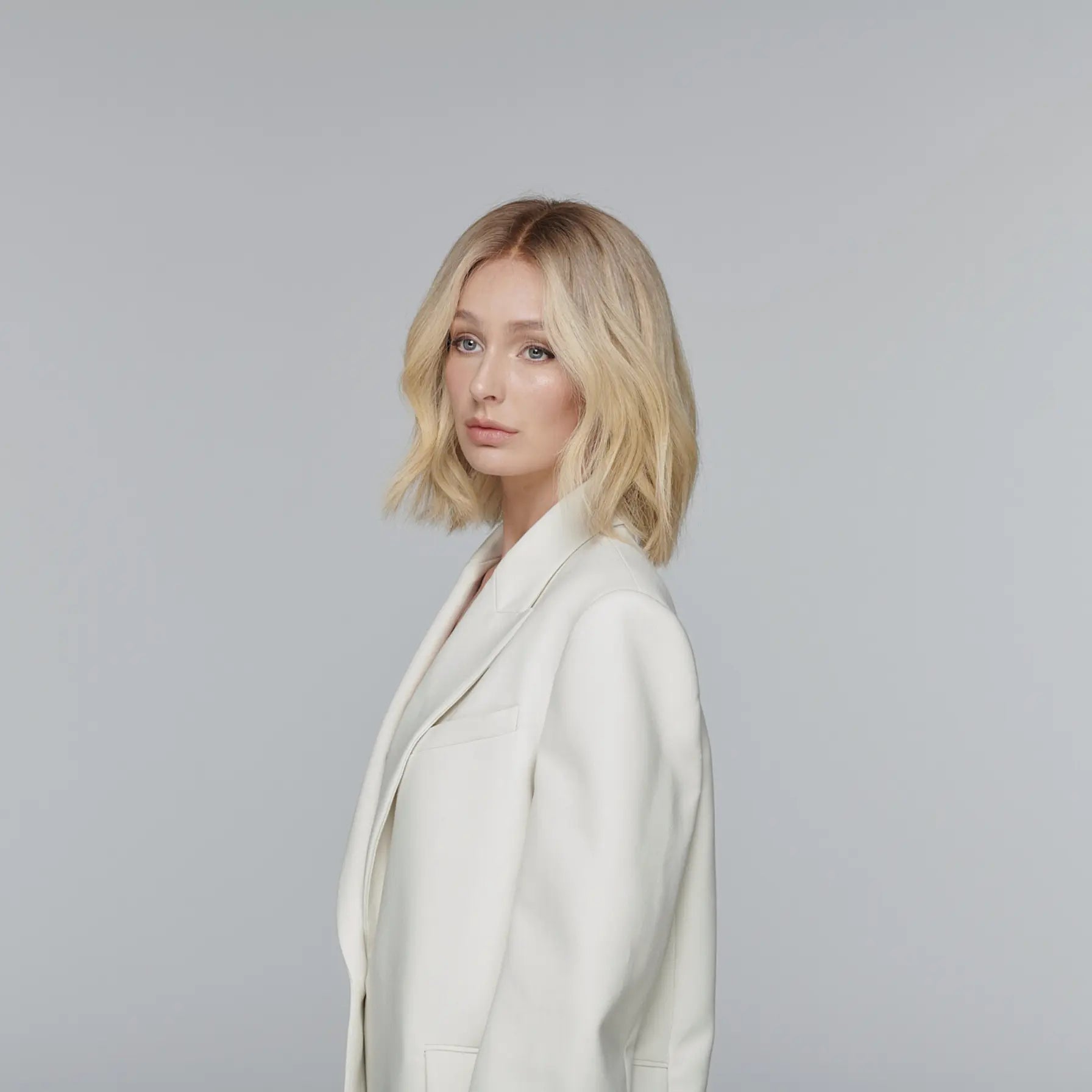 Close-up of the Healthy Butter Blonde lace front wig shade showing its soft, creamy blonde tones with subtle pale-gold highlights and seamless color blending.