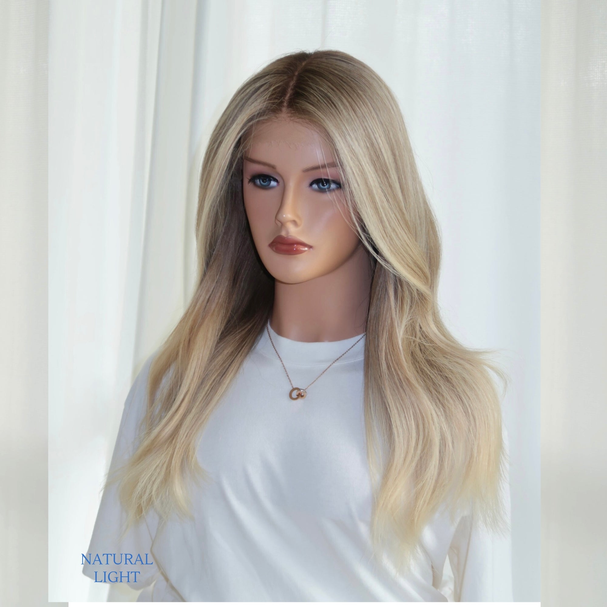 Fits All creamy blonde lace top wig by Madeline Aken, showing soft neutral tones and a seamless lace front for a natural, glueless fit.