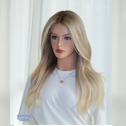 Fits All creamy blonde lace top wig by Madeline Aken, showing soft neutral tones and a seamless lace front for a natural, glueless fit.