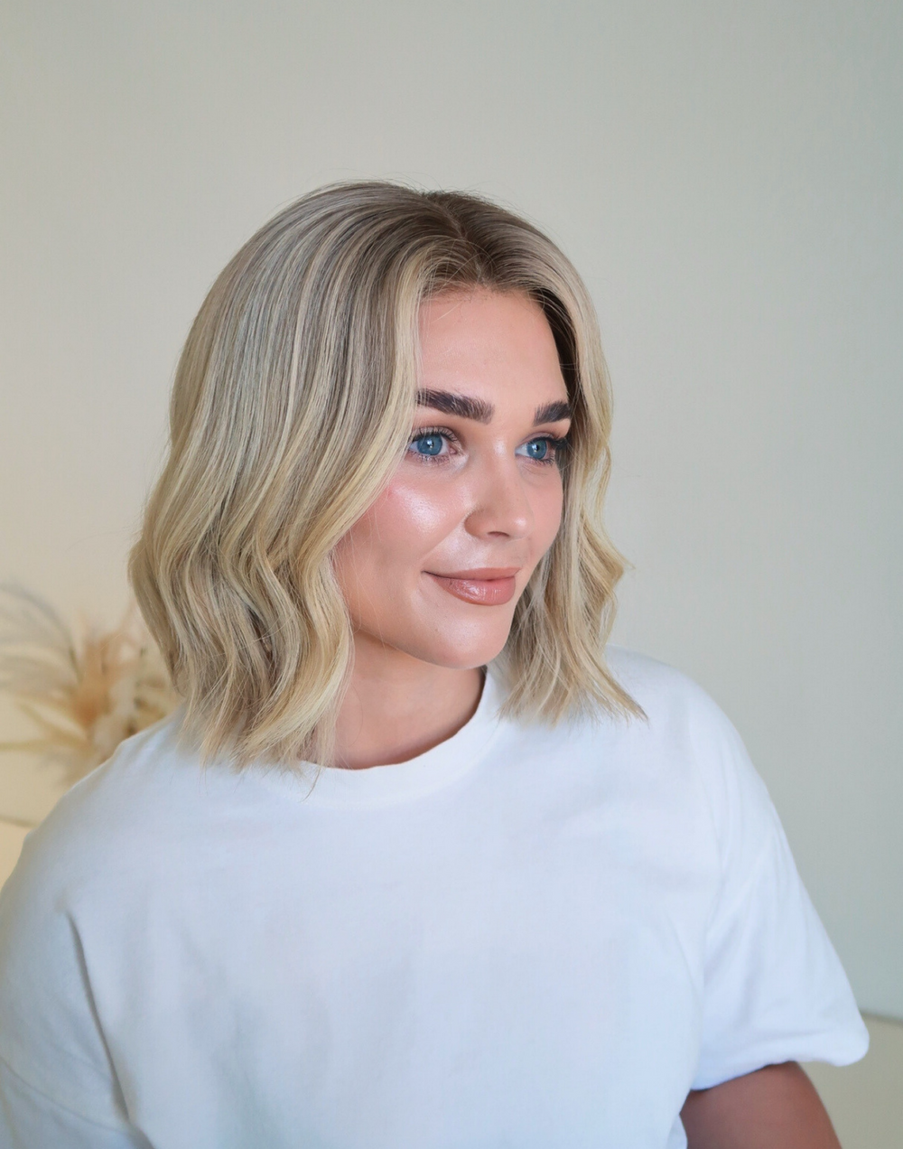 Model wearing the Healthy Butter Blonde bob wig with a creamy blonde tone