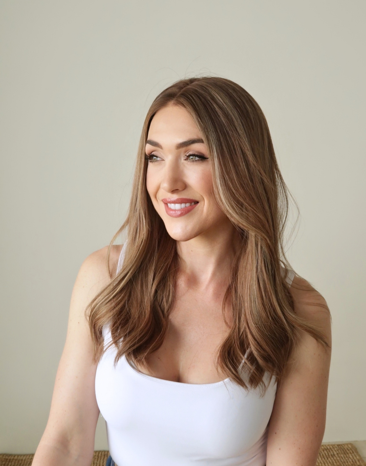 Side view of Amber 18-inch brown Remy human hair wig, featuring warm brunette tones, subtle highlights, and natural hair movement.