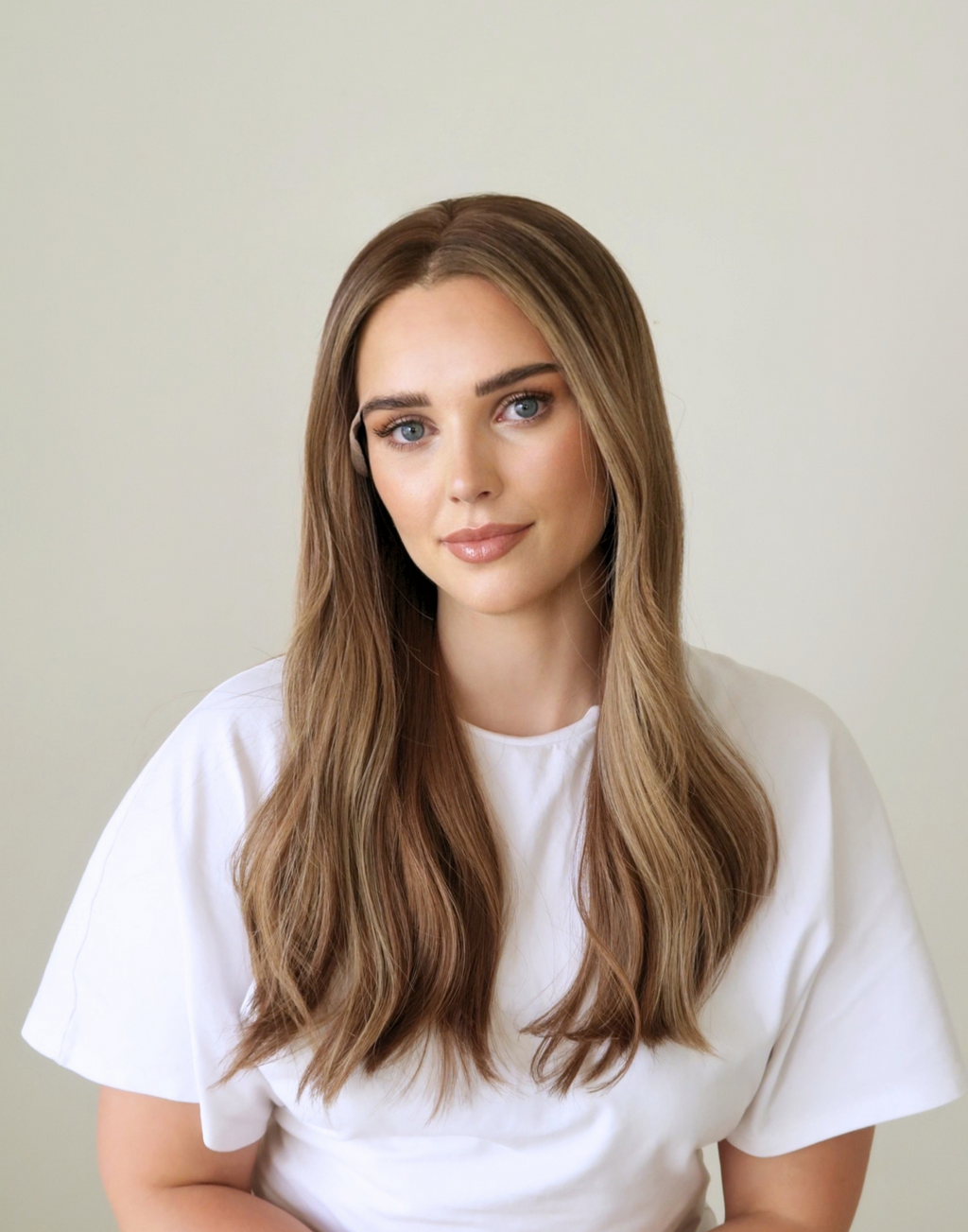 Front view of Amber 20-inch toasted almond brown human hair wig, showing warm brunette tones and softly blended highlights.