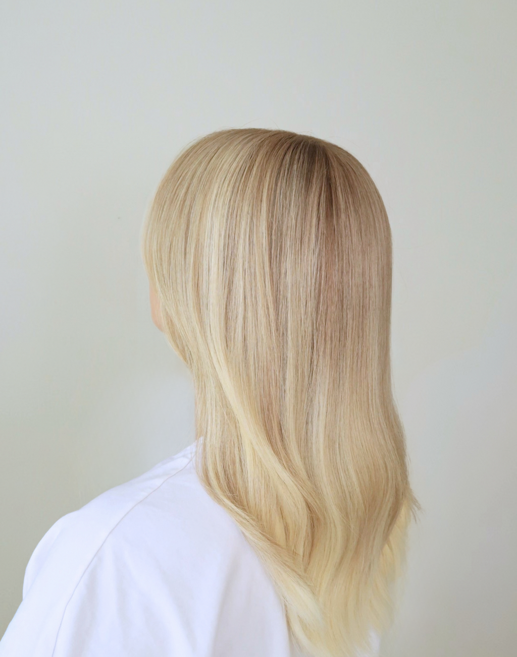 Three-quarter view of Chantilly vanilla blonde wig, showing fine blonde babylights and softly blended dimensional color.