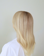 Three-quarter view of Chantilly vanilla blonde wig, showing fine blonde babylights and softly blended dimensional color.