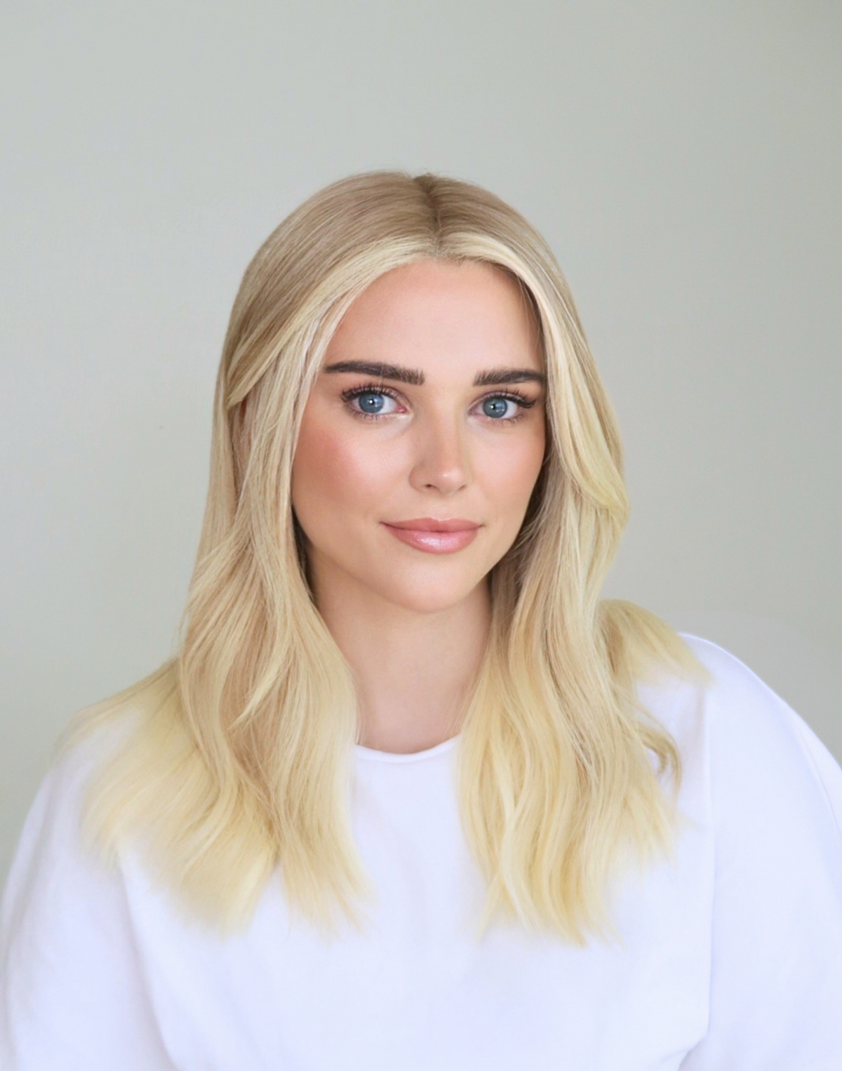 Close-up of Chantilly vanilla blonde hair color, highlighting fine babylights, subtle root shading, and softly blended blonde tones.