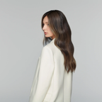 Model wearing dark caramel highlight brunette human hair wig with glueless lace front for effortless wear