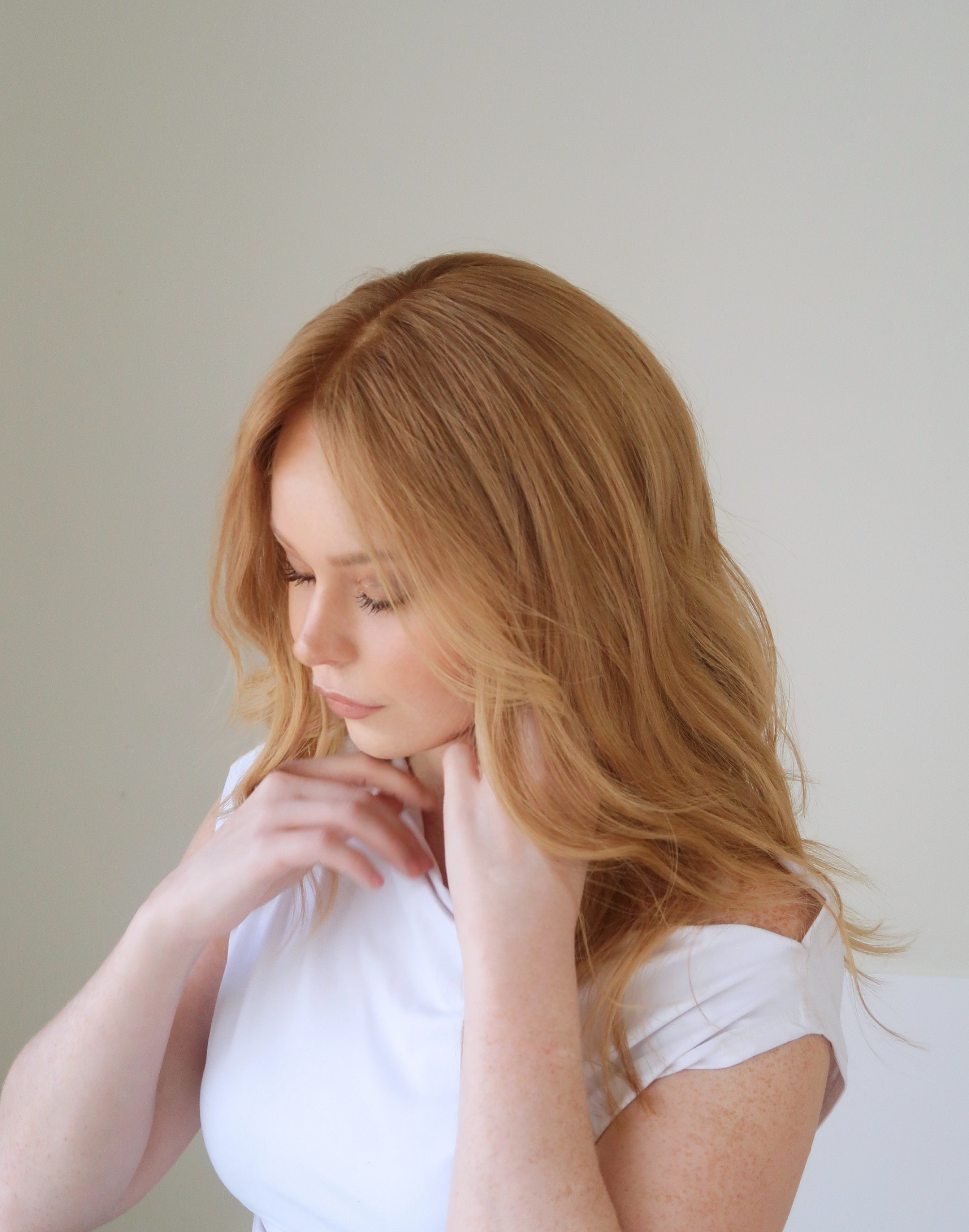 Apricot lace top wig in natural daylight showing its luminous ginger blonde color