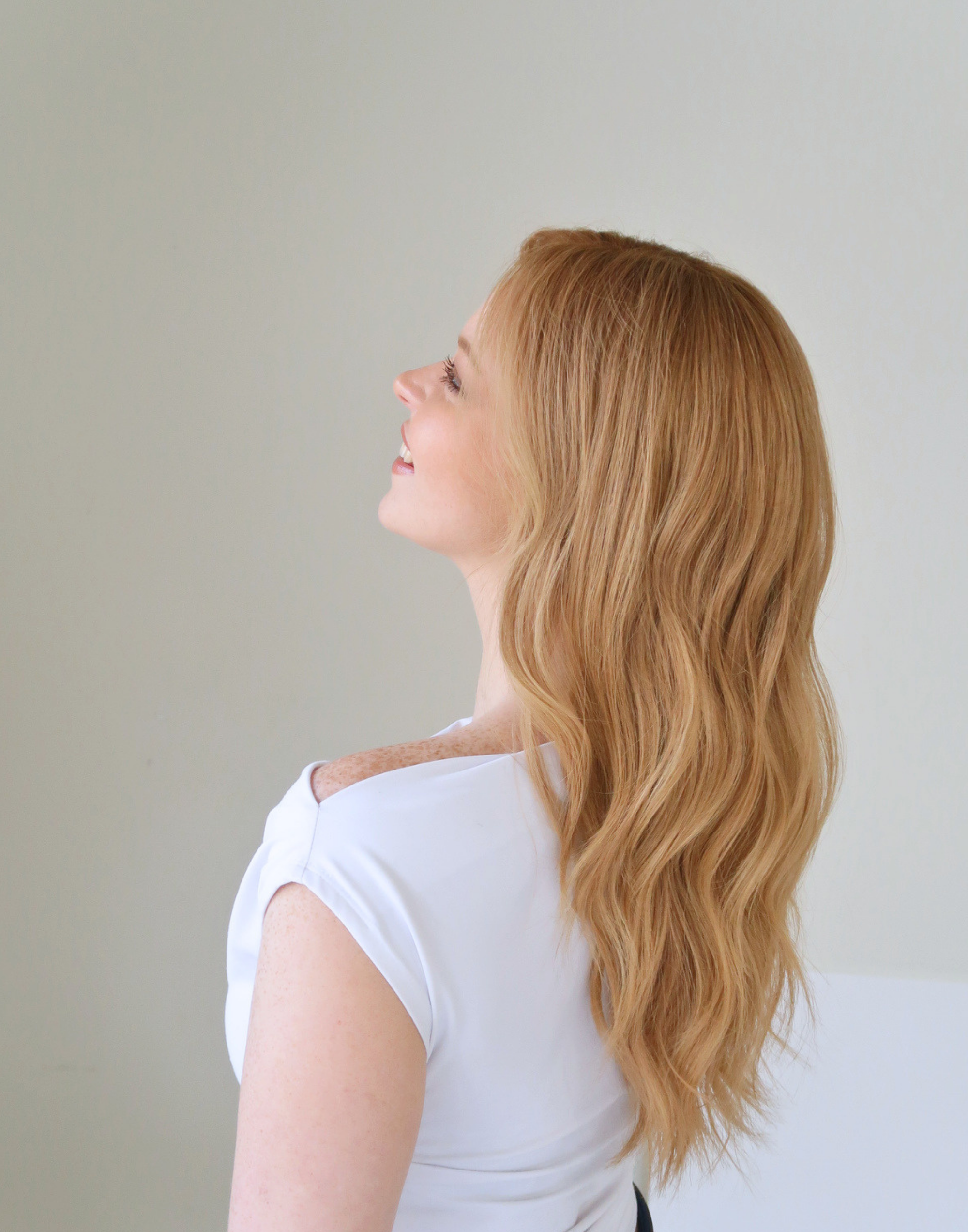 Side profile of Apricot golden ginger blonde human hair wig with soft tonal blending