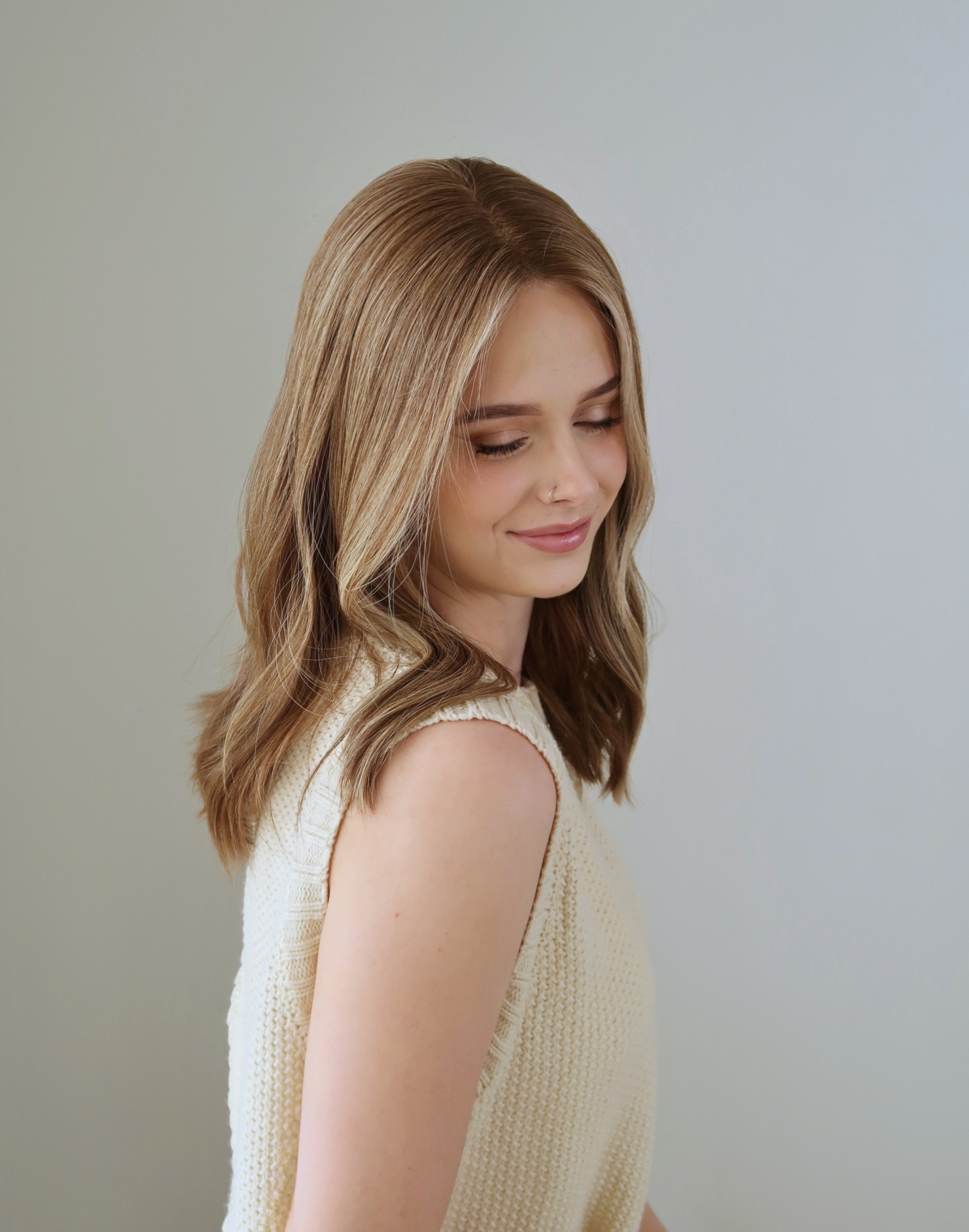 Side profile of Marlowe chestnut brown human hair wig with very fine golden highlights
