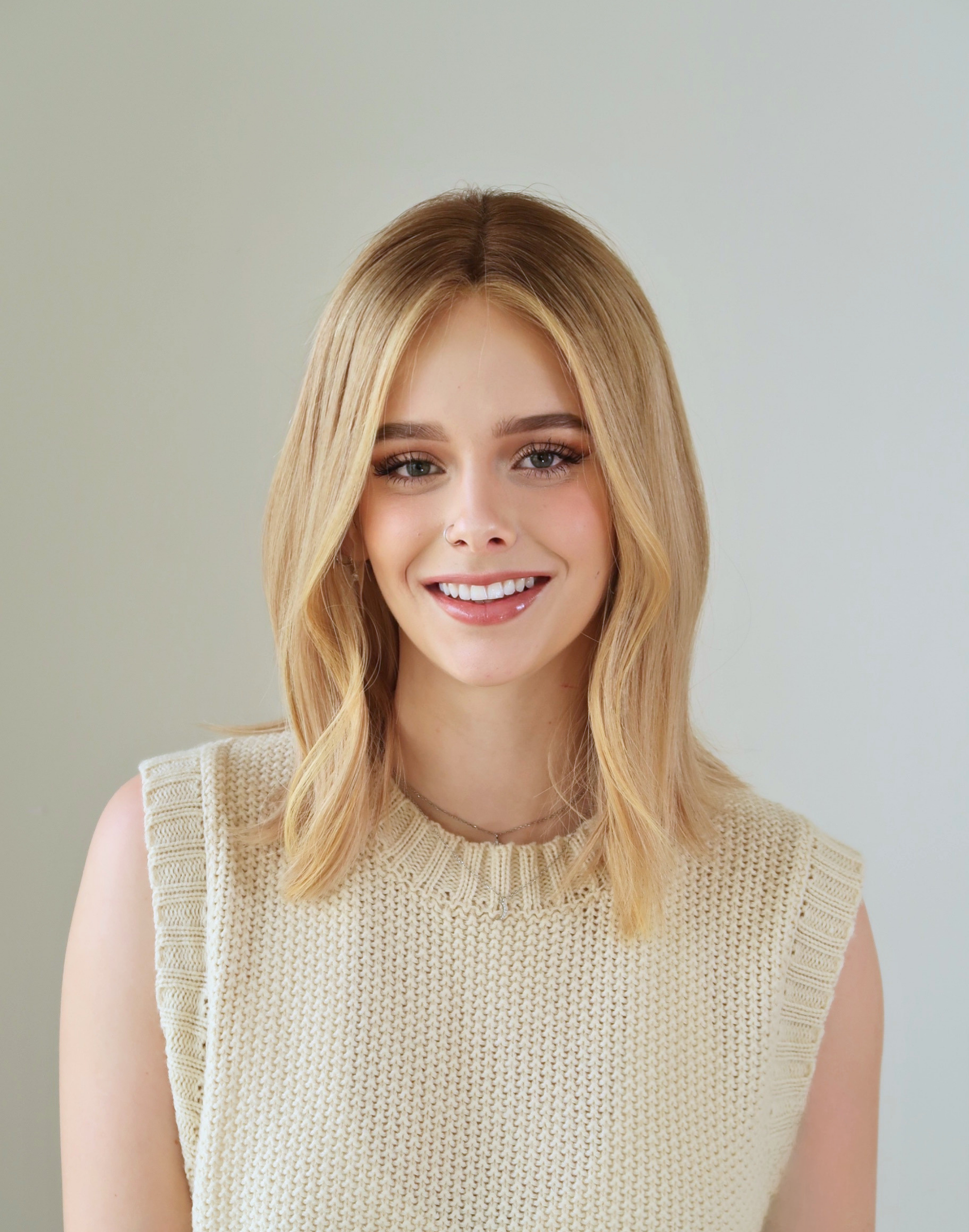 Front view of Mica beige blonde Remy human hair wig with a deep brown root and soft tonal dimension