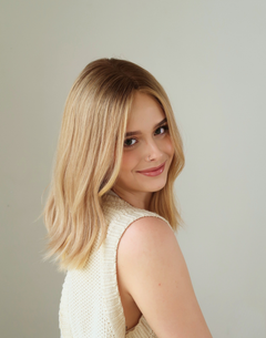 Side profile of Mica beige blonde Remy human hair wig with a softly blended deep root