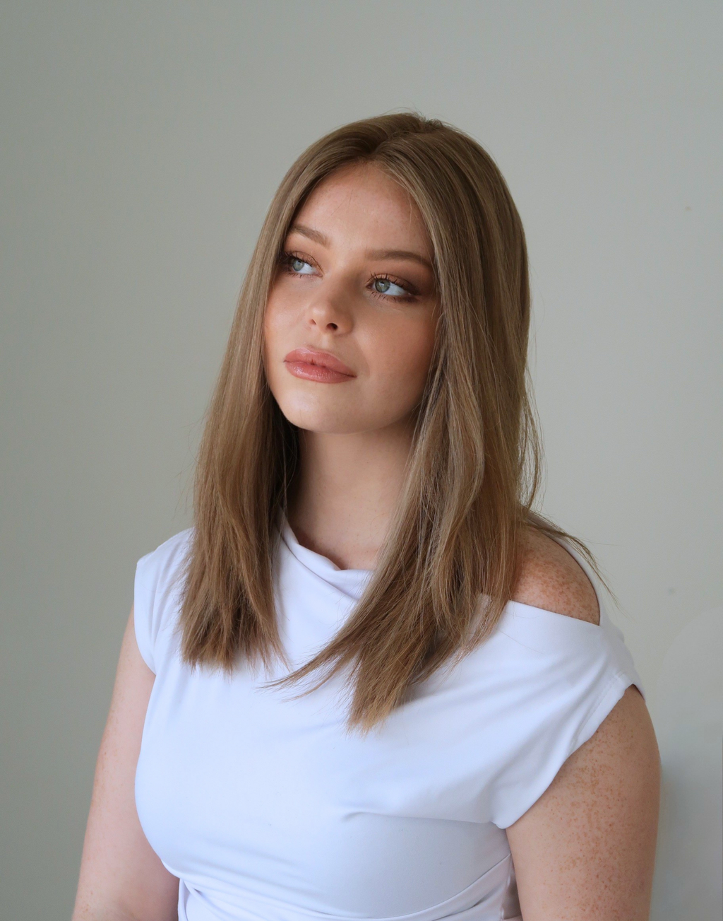 Tawny brown lace top wig in natural daylight showing subtle brunette dimension
