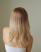 Back view of Sauternes honey blonde wig with a soft brown root and pale beige lengths