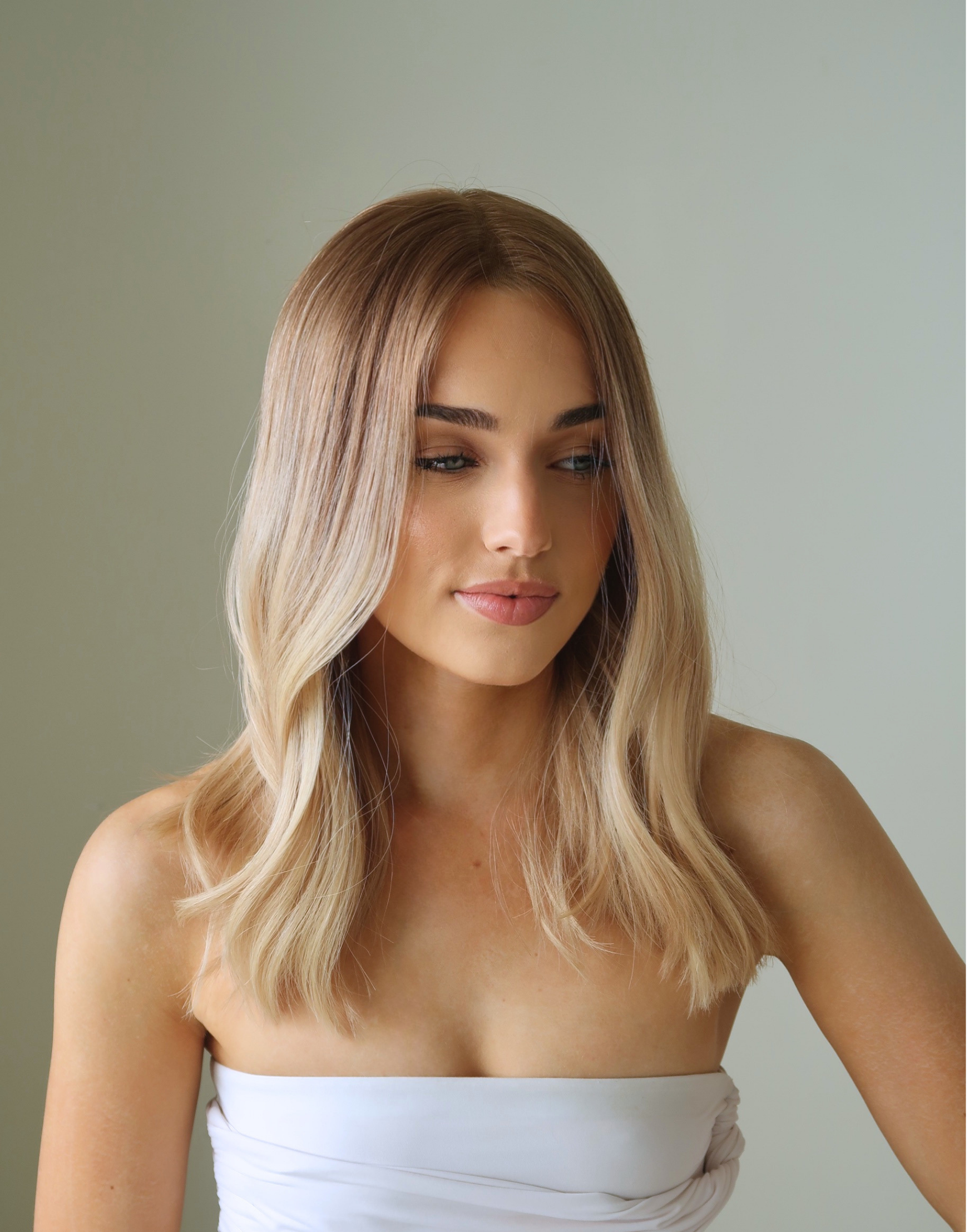 Side profile of Sauternes honey blonde human hair wig with soft root depth