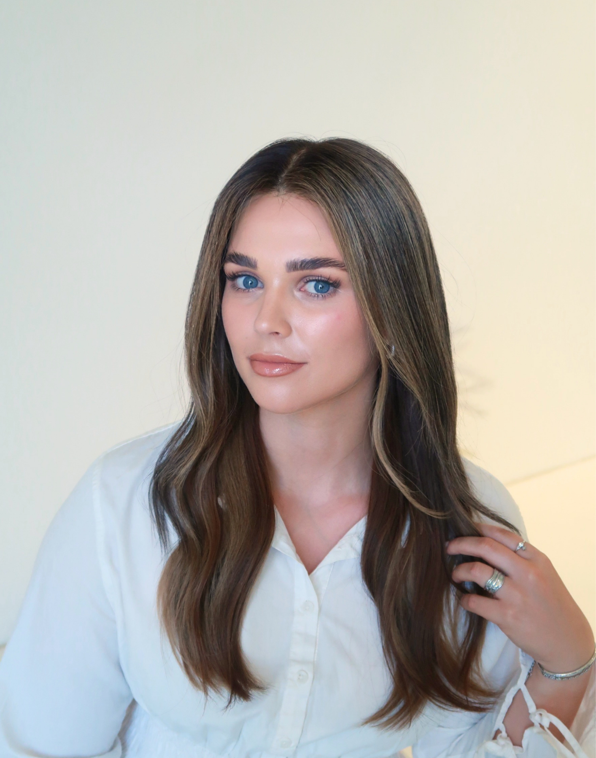Front view of Truffle deep brunette human hair wig with defined toffee babylights