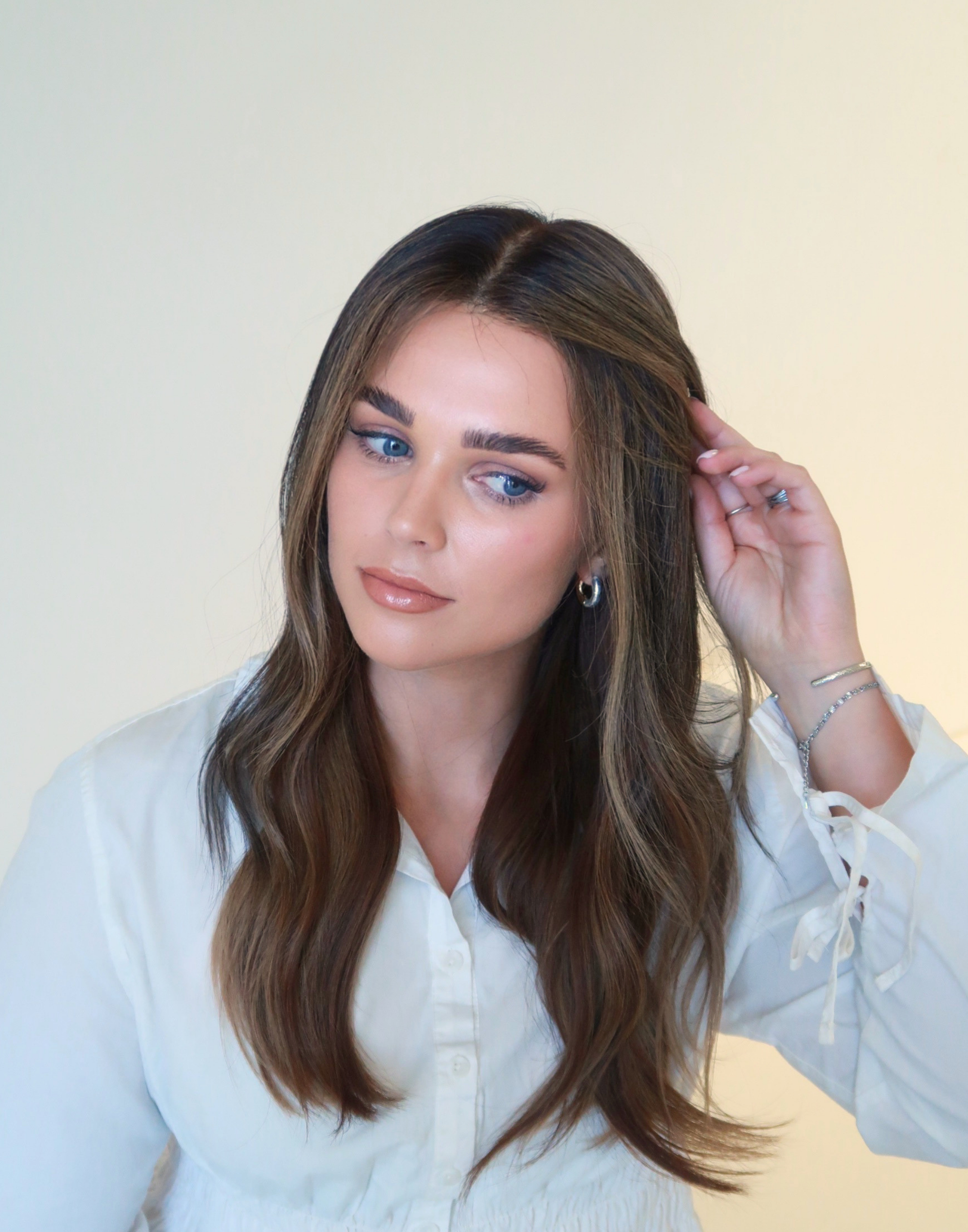 Truffle brunette lace top wig in natural daylight showing contrasting toffee highlights