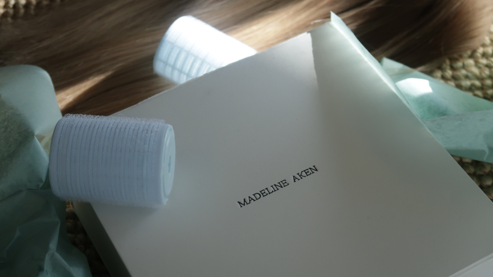 Madeline Aken wig packaging with human hair in natural light
