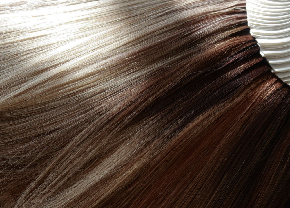 A selection of Madeline Aken human hair wigs arranged together, showing a range of colors from blonde to brunette