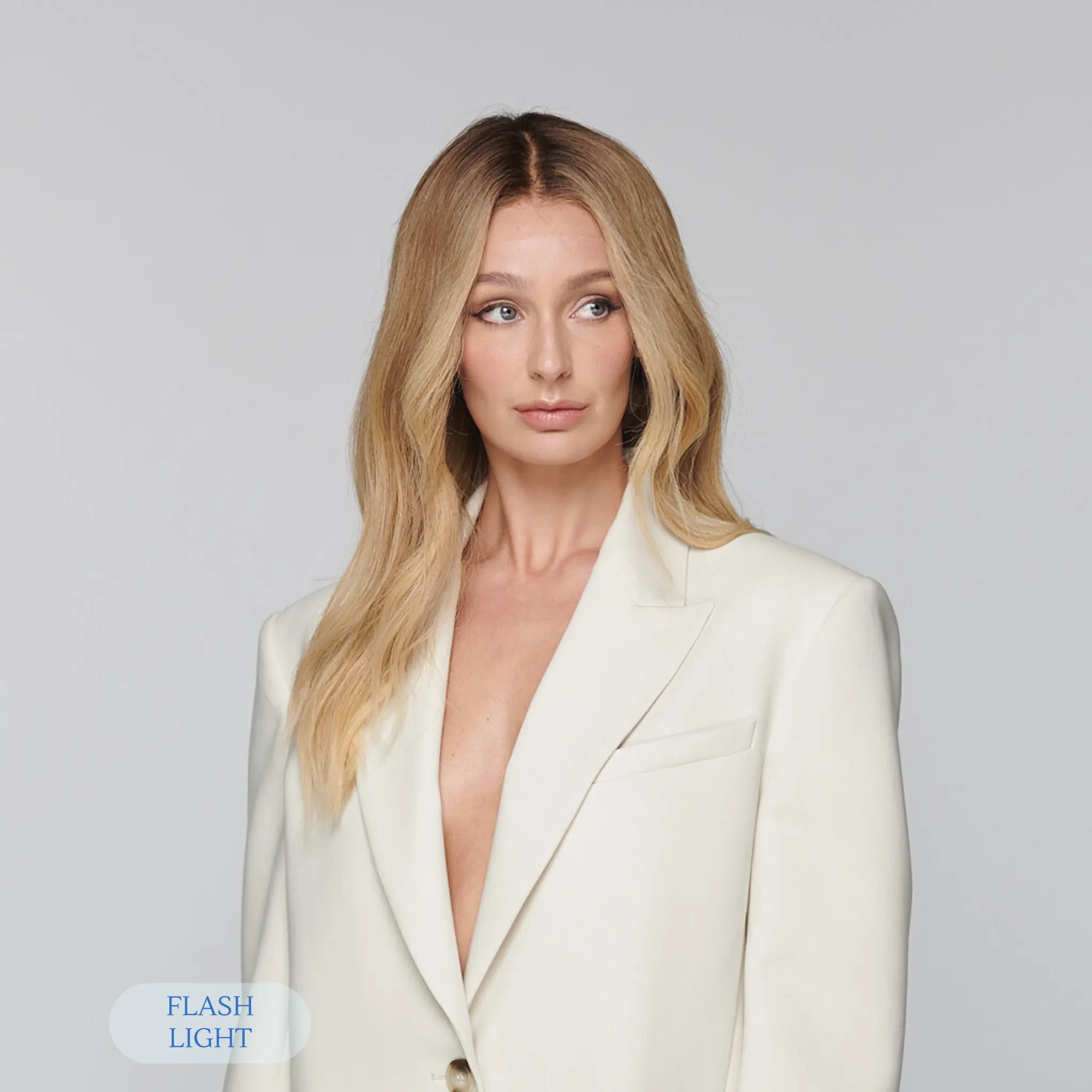 Model wearing sunkissed honey blonde human hair wig with dark rooted base and glueless lace front for effortless glow