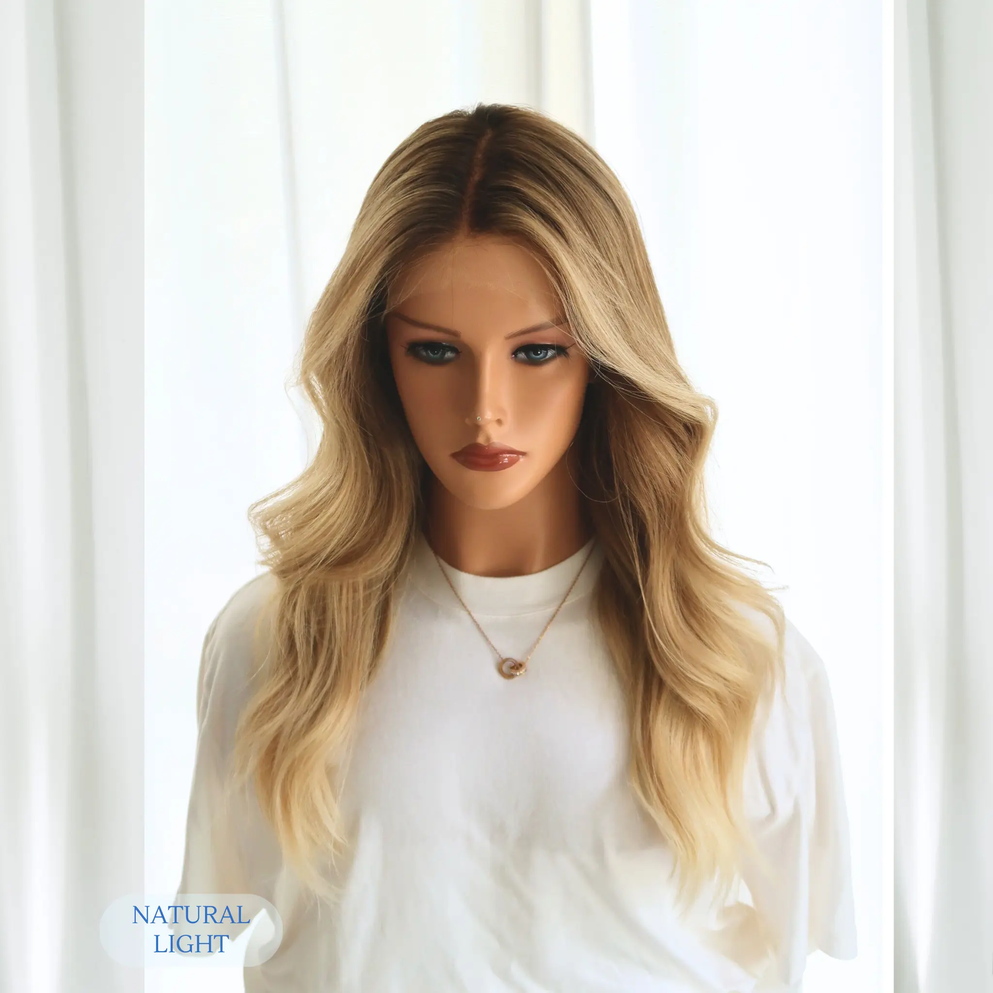 Natural light outdoor shot of sunkissed honey blonde human hair wig, 20 inch, with golden highlights and dark rooted base