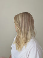 Chantilly vanilla blonde Remy human hair wig in motion, showing the soft movement and delicate tonal variation of the blonde hair.