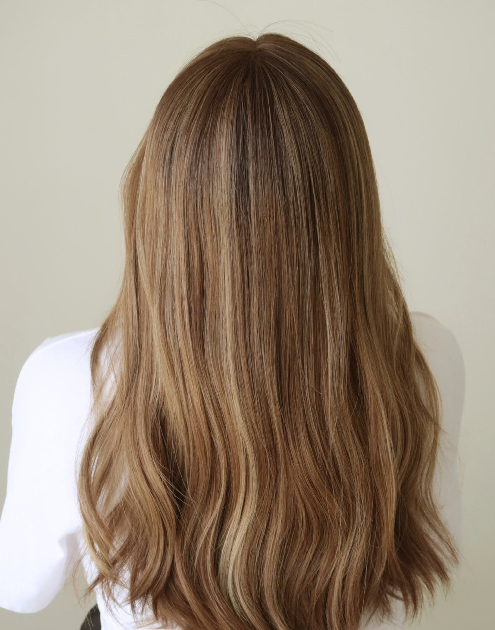Amber 20-inch toasted almond brown Remy human hair wig in motion, showing natural movement and warm brunette color variation.