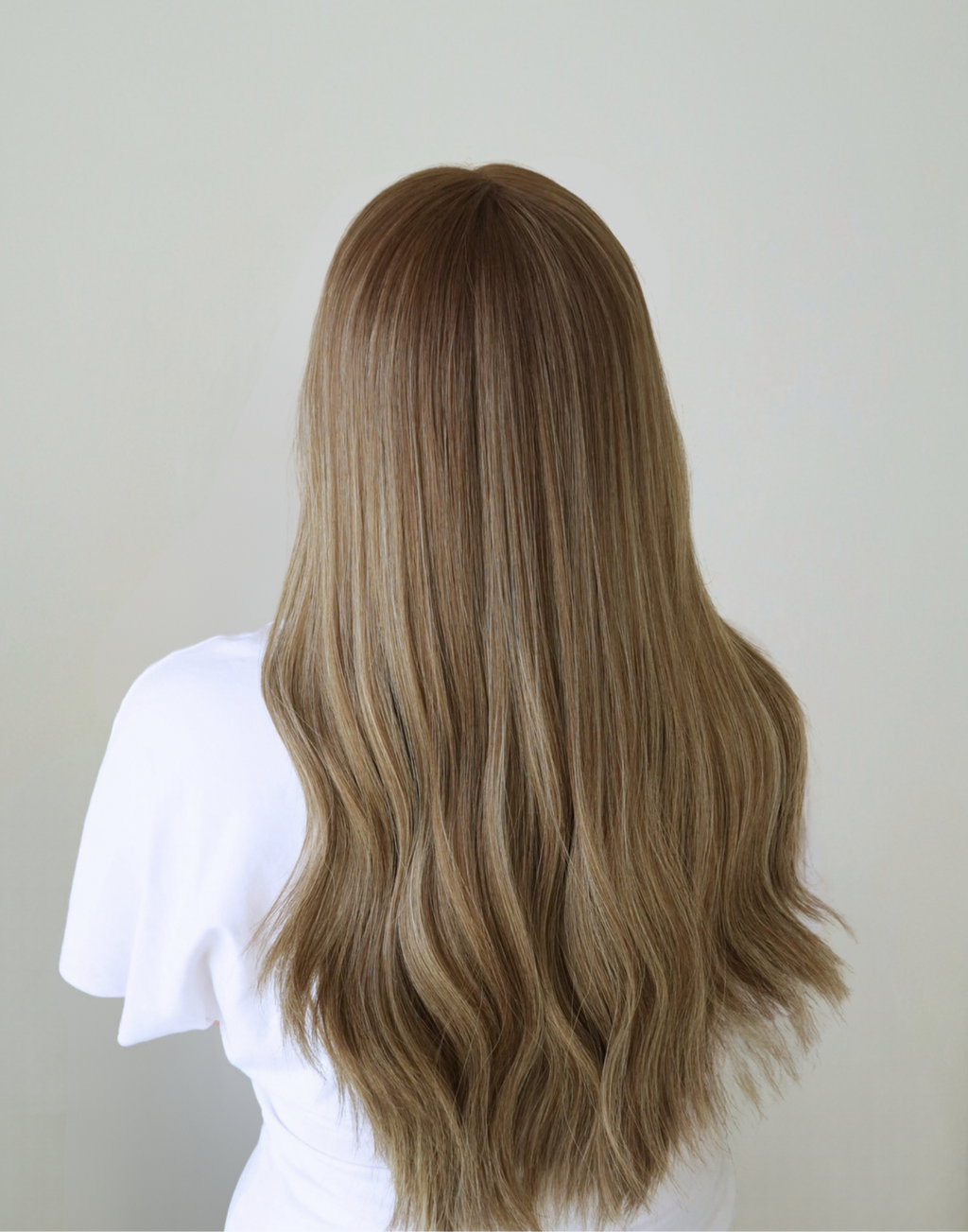 Back view of Serein human hair wig featuring muted mushroom brown with fine ash brown highlights and dimensional color throughout.