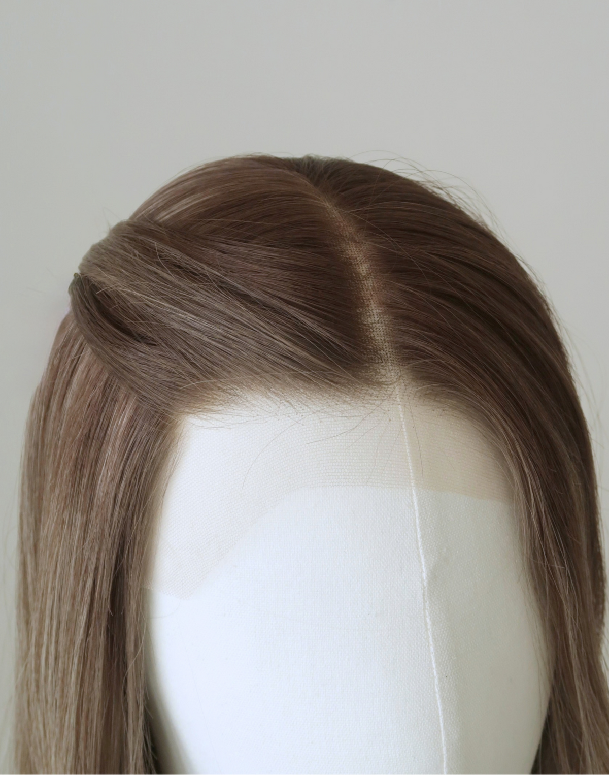 Close-up of Serein glueless Remy human hair wig showing its lace hairline, natural-looking parting, and softly shaded roots.