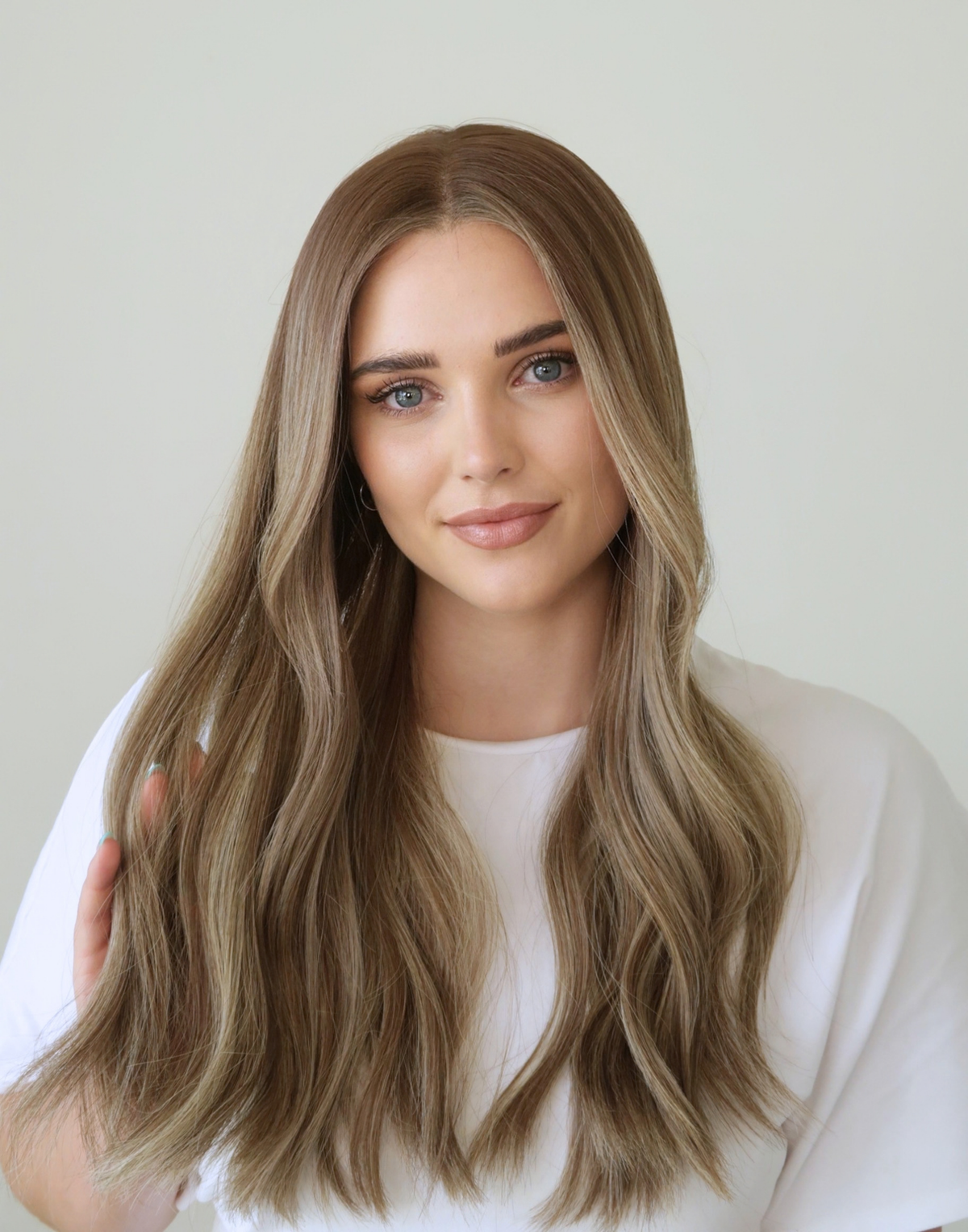 Detailed view of Serein mushroom bronde hair color, combining a muted brown base, umber roots, and delicate ash brown highlights.