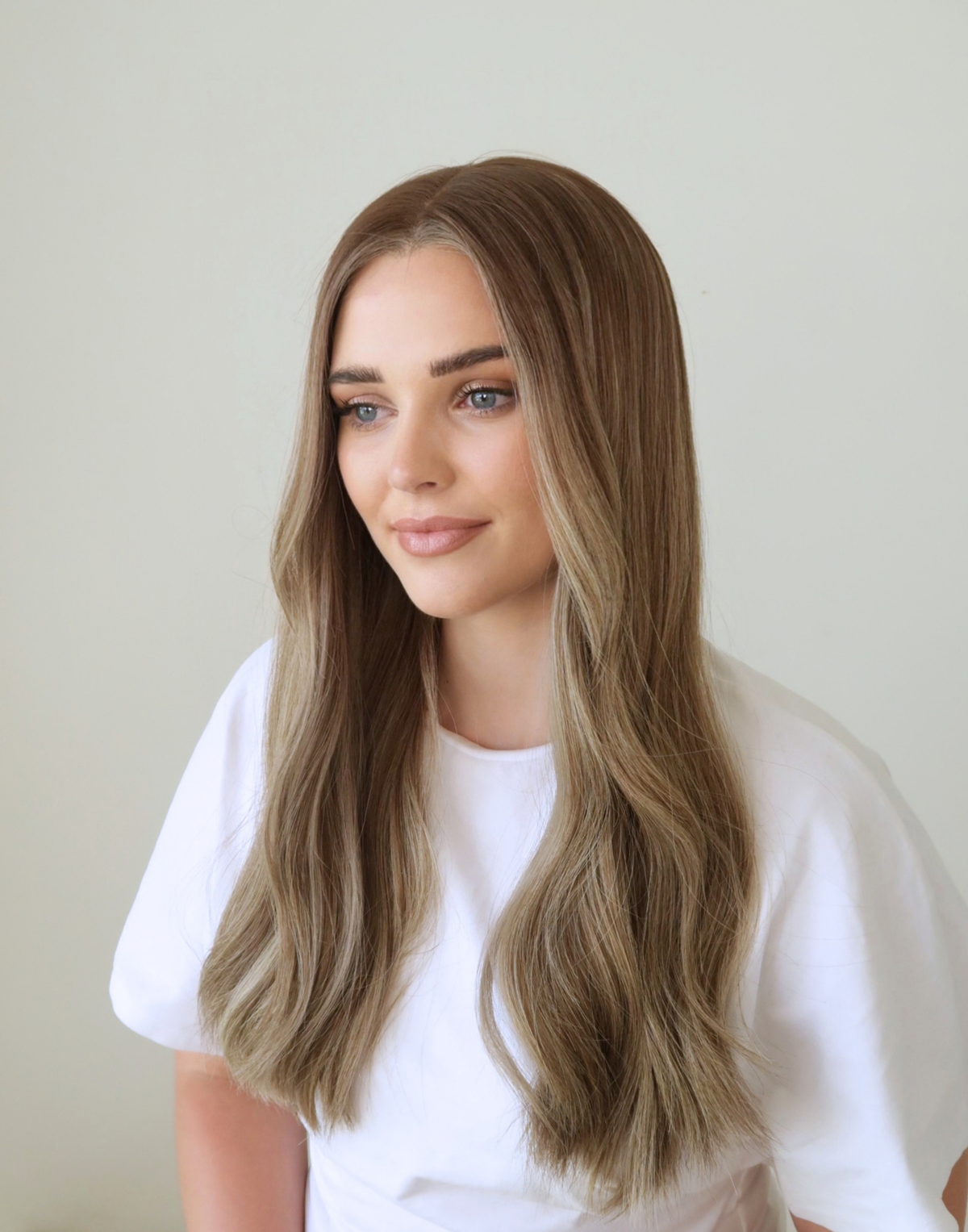 Side view of Serein mushroom brown human hair wig, showing the softly blended ash bronde tones and natural fall of the hair.